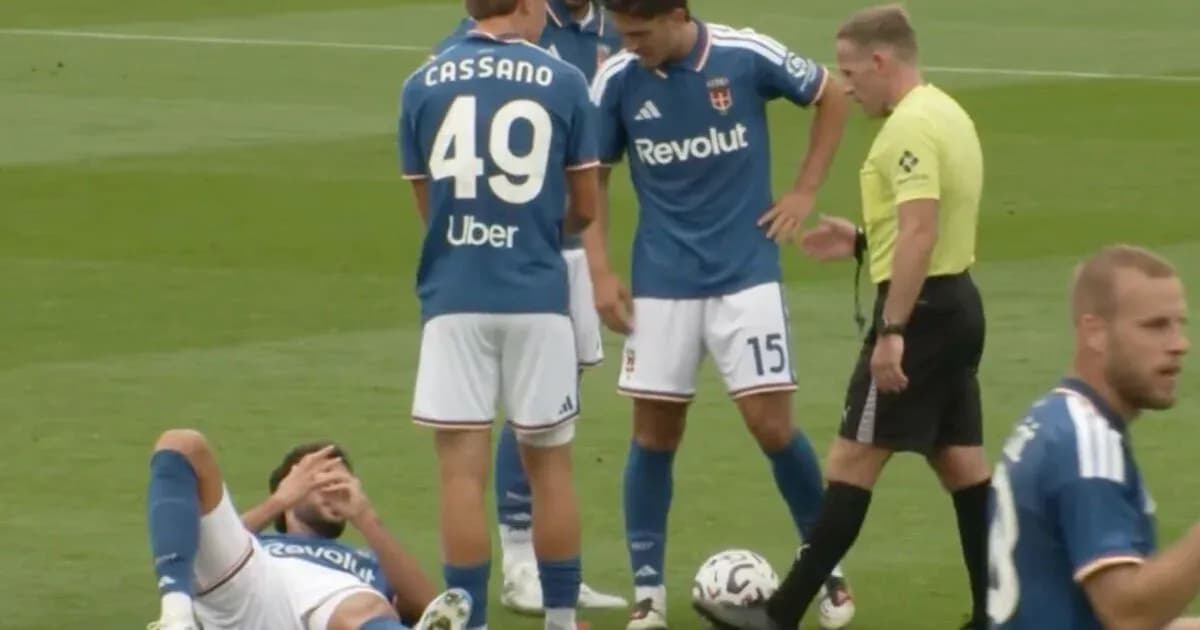 Players gathered around injured teammate on field