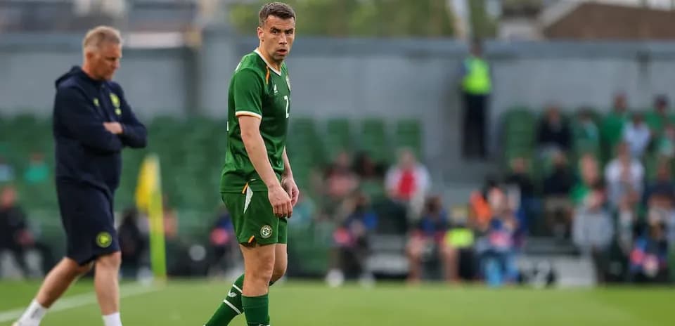 Ireland player on field during match with coach nearby