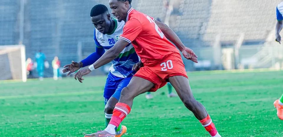Two players competing for the ball on the field