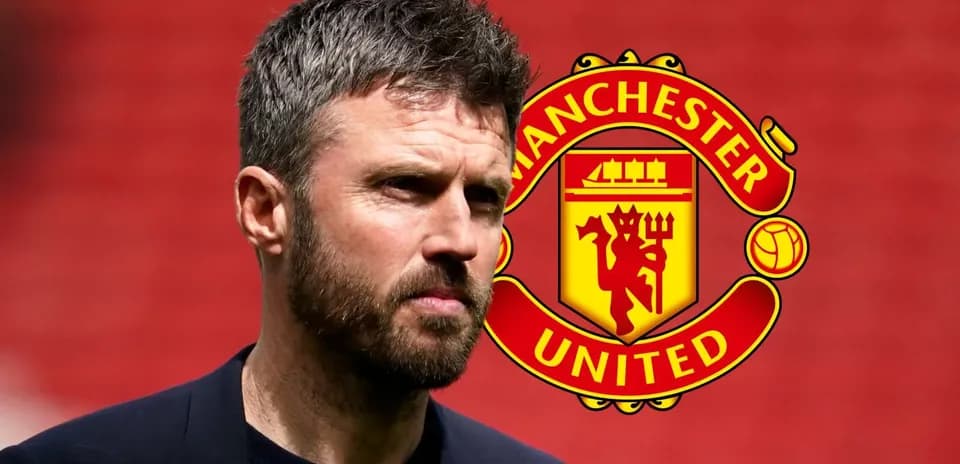 Coach standing in front of Manchester United logo