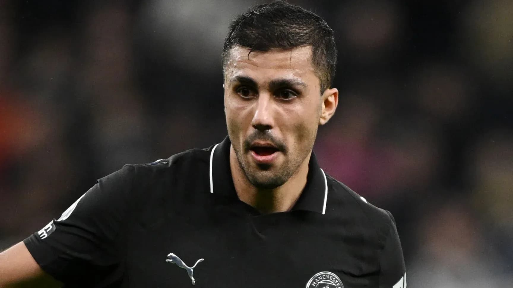 Player in black jersey during match action