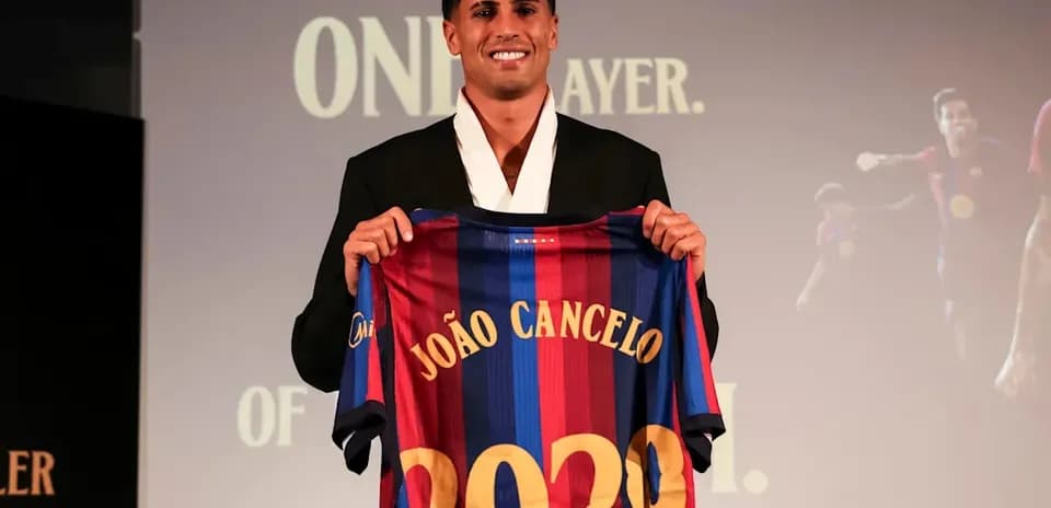 João Cancelo holding Barcelona jersey with 2029