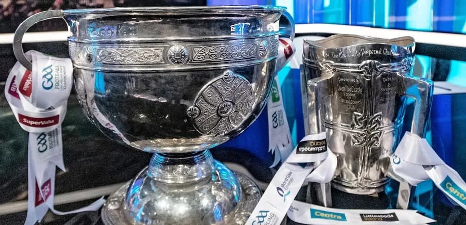 GAA trophies on display with ribbons