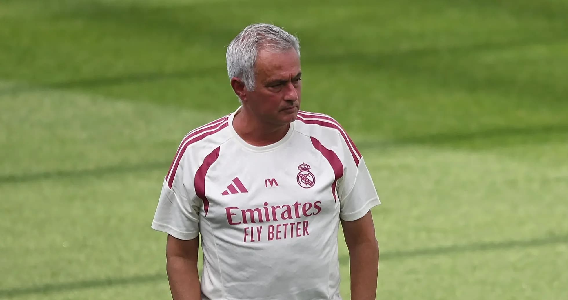 Manager walking on training pitch in team kit