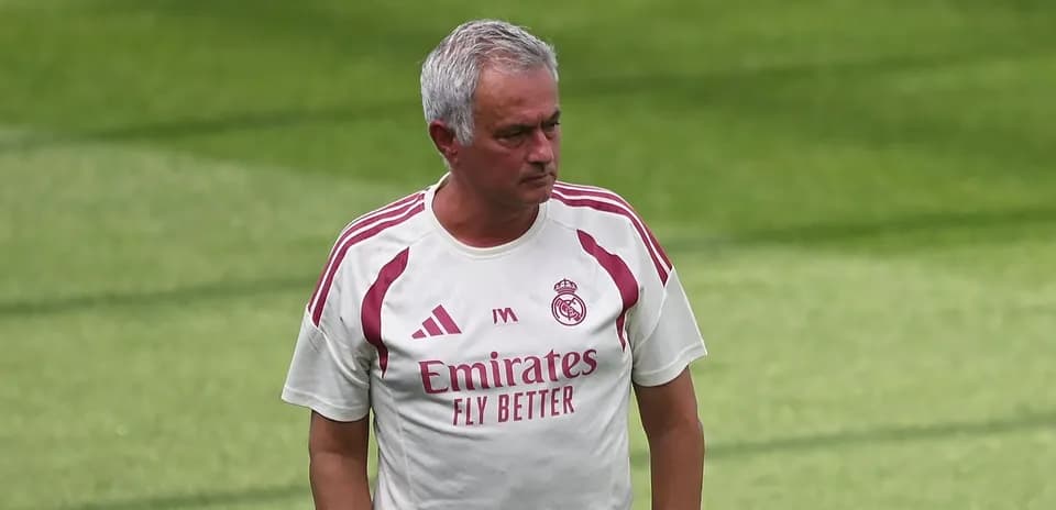 Manager walking on training pitch in team kit