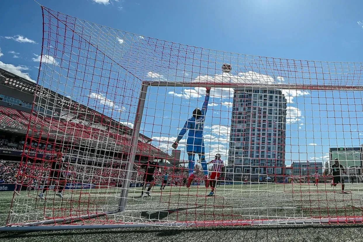 Goalkeeper reaching for the ball during match