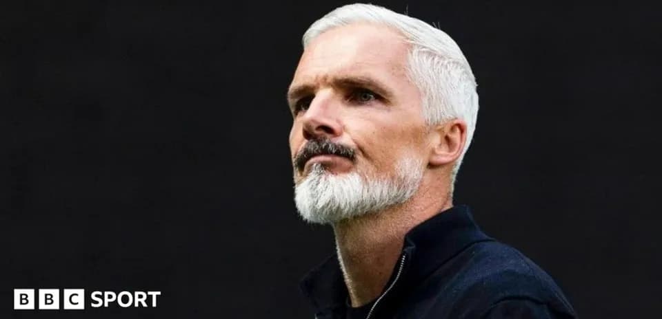 Coach with white hair and beard in profile