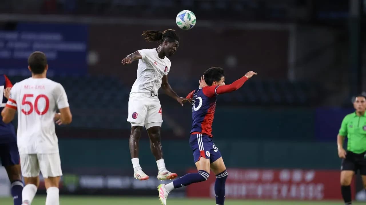 Player jumping to head the ball during match