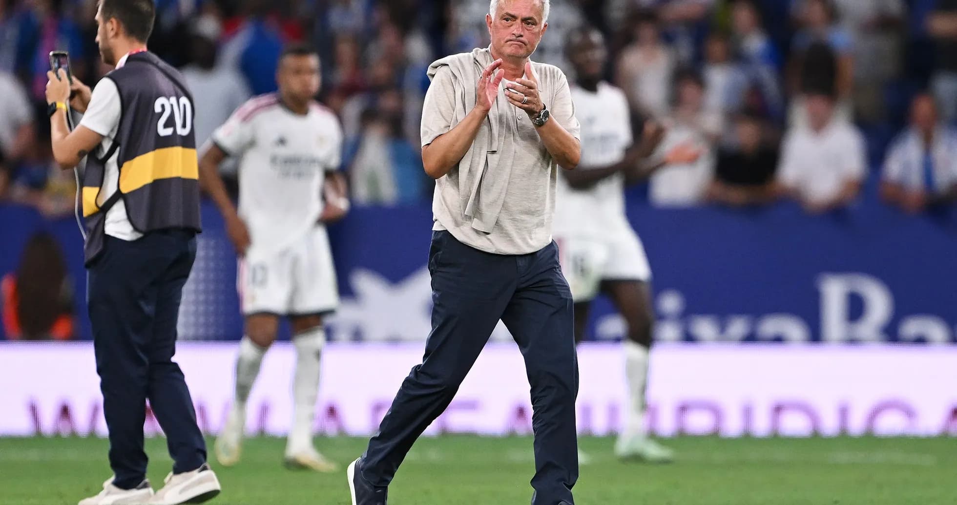 Manager applauding players during a match