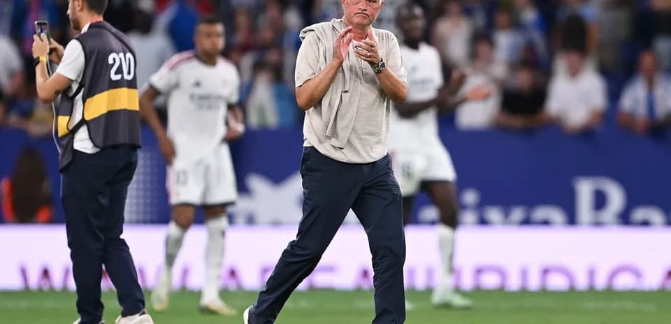 Manager applauding players during a match