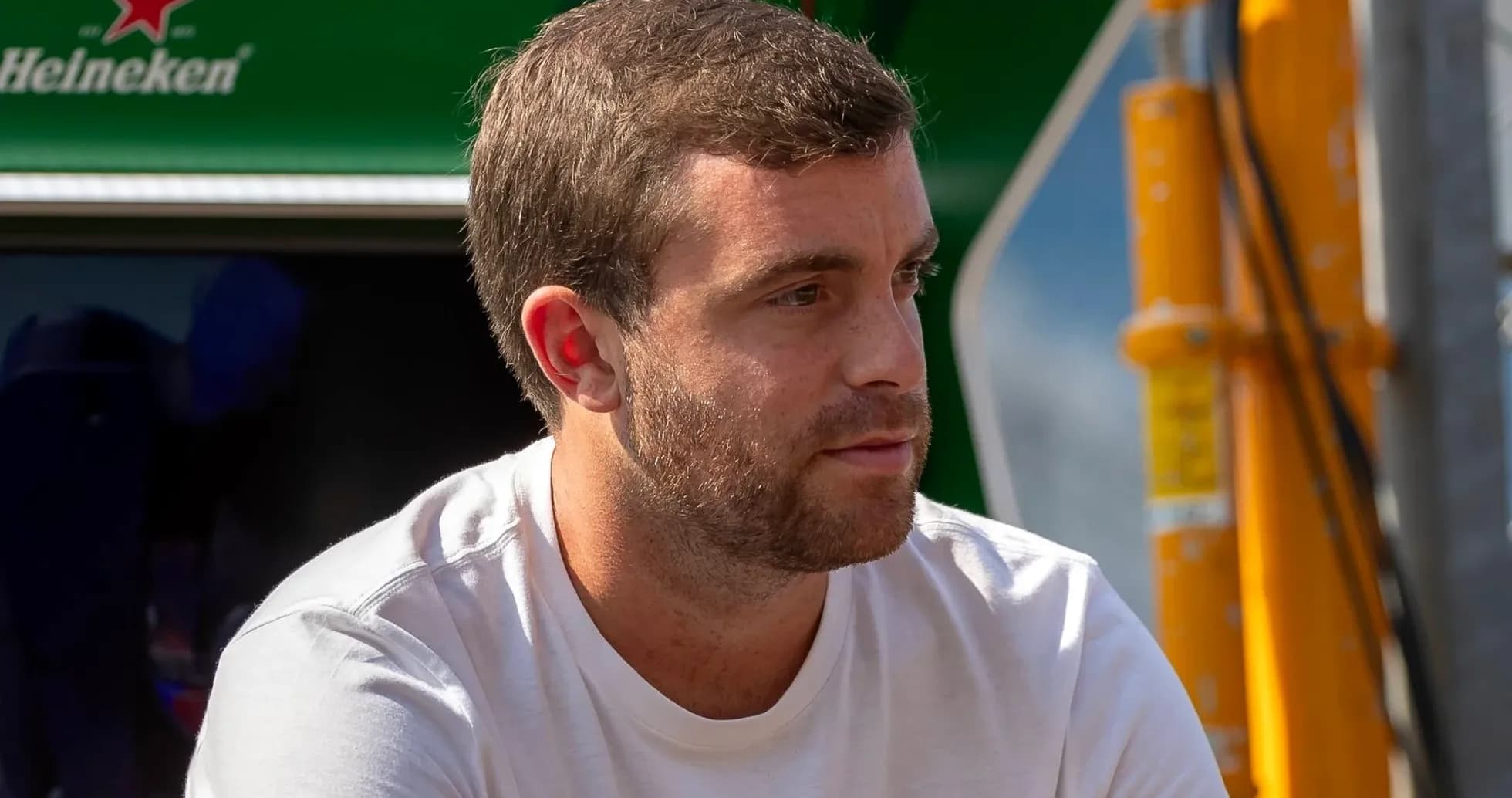 Man sitting near racing team equipment