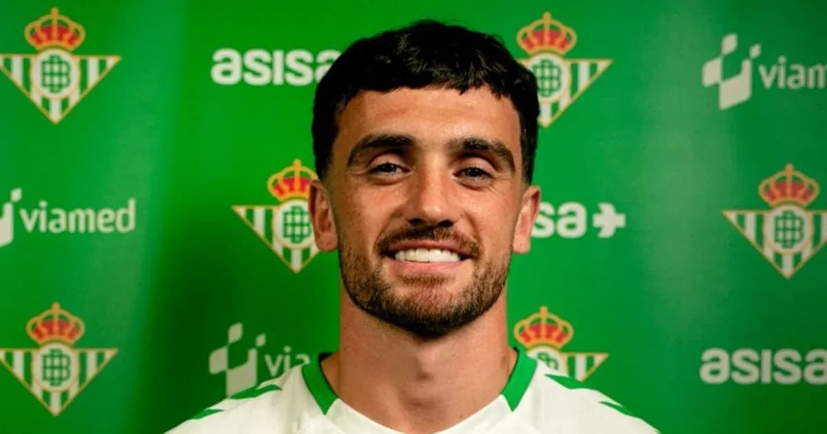 Player posing in front of Real Betis backdrop