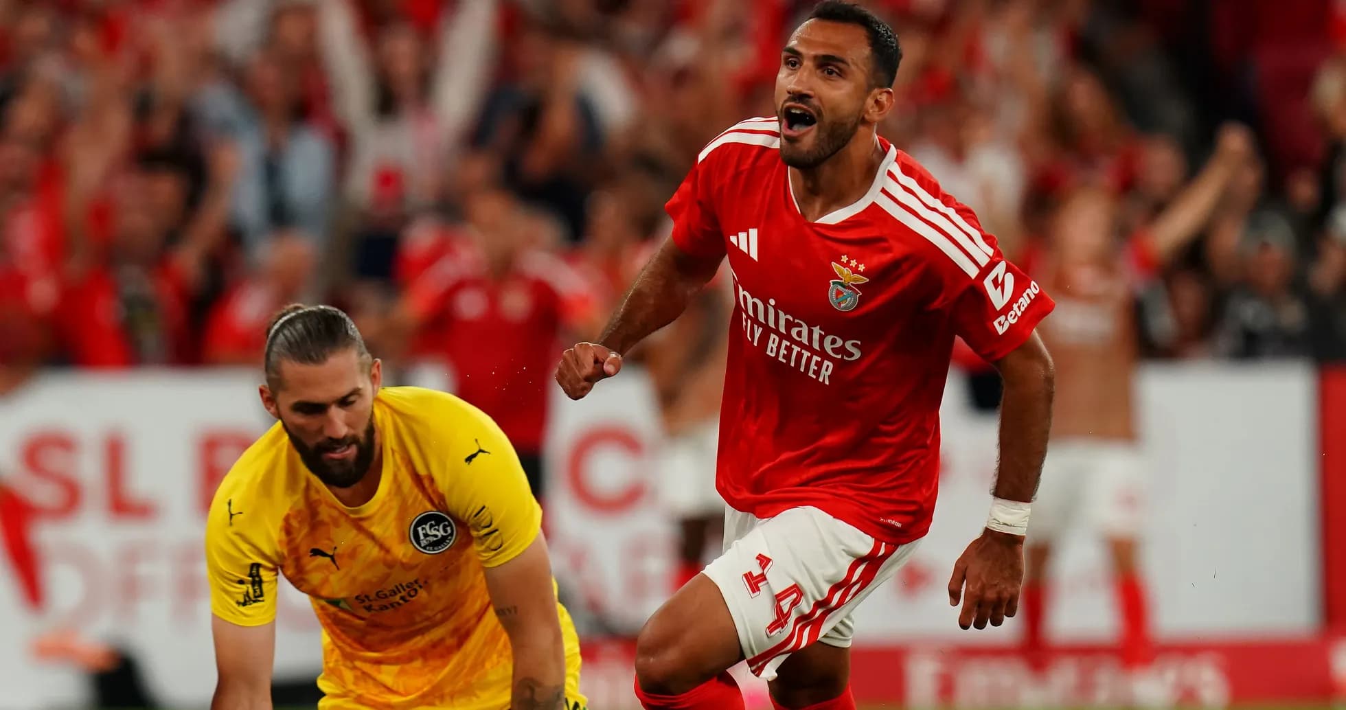 Benfica player celebrating a goal against goalkeeper