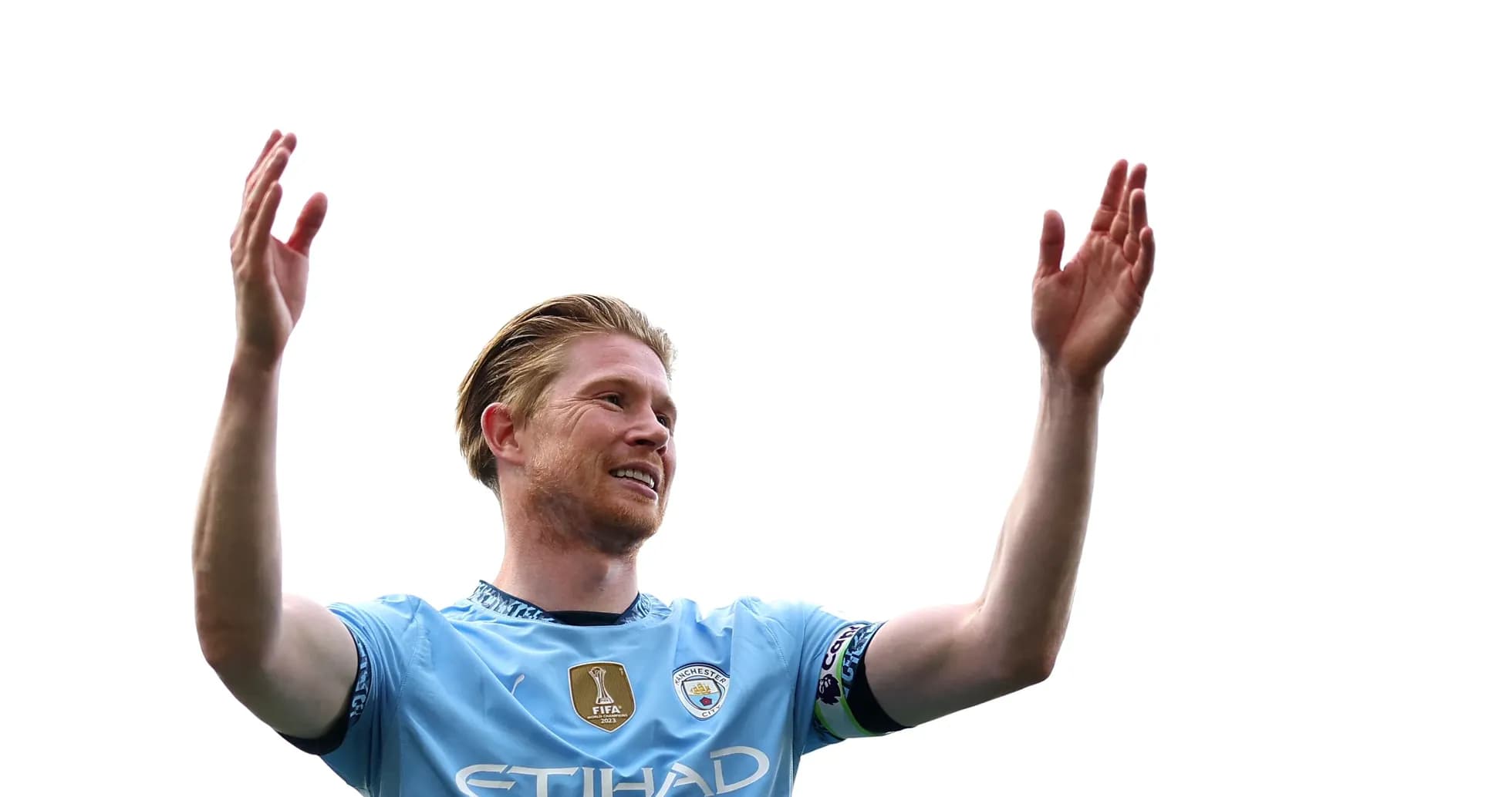 Player celebrating with raised arms on pitch