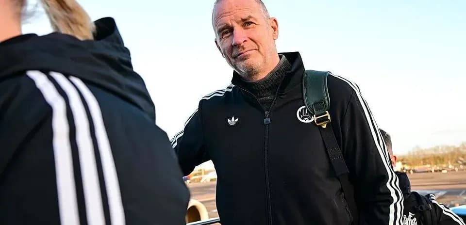 Coach in black tracksuit at airport departure