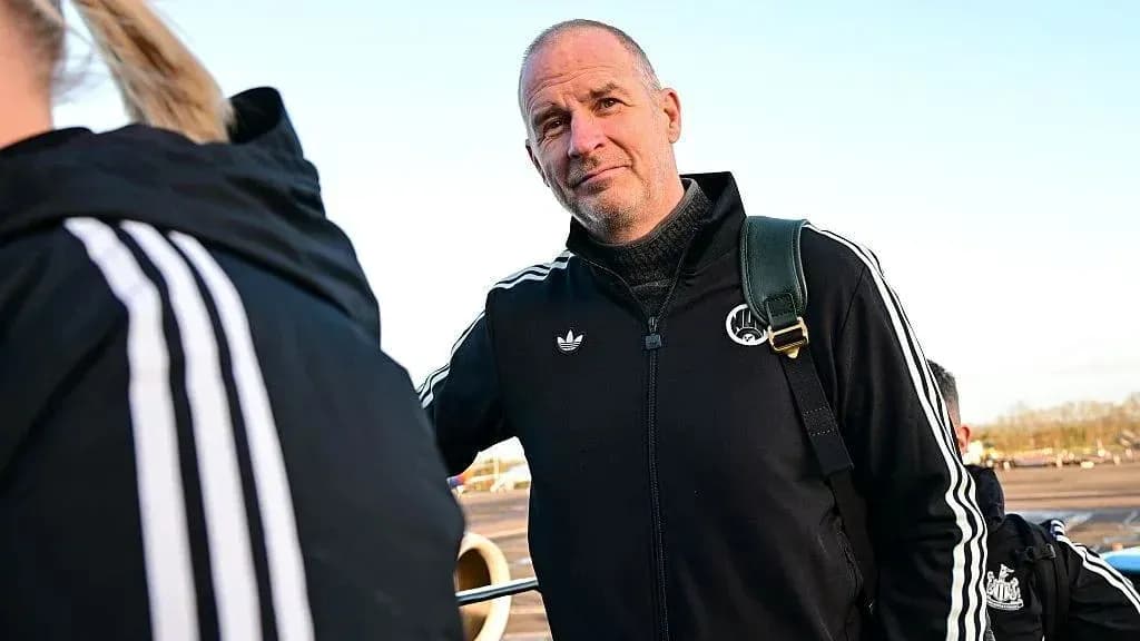 Coach in black tracksuit at airport departure
