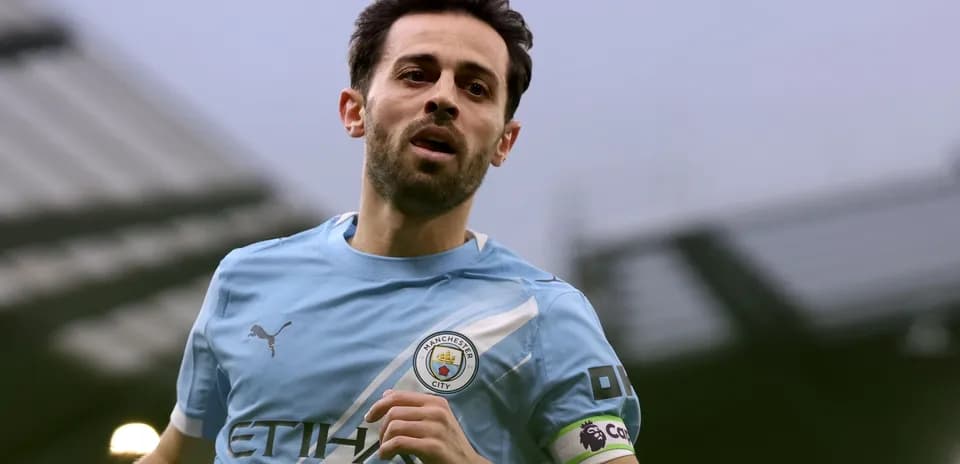 Player running on the pitch wearing Manchester City kit