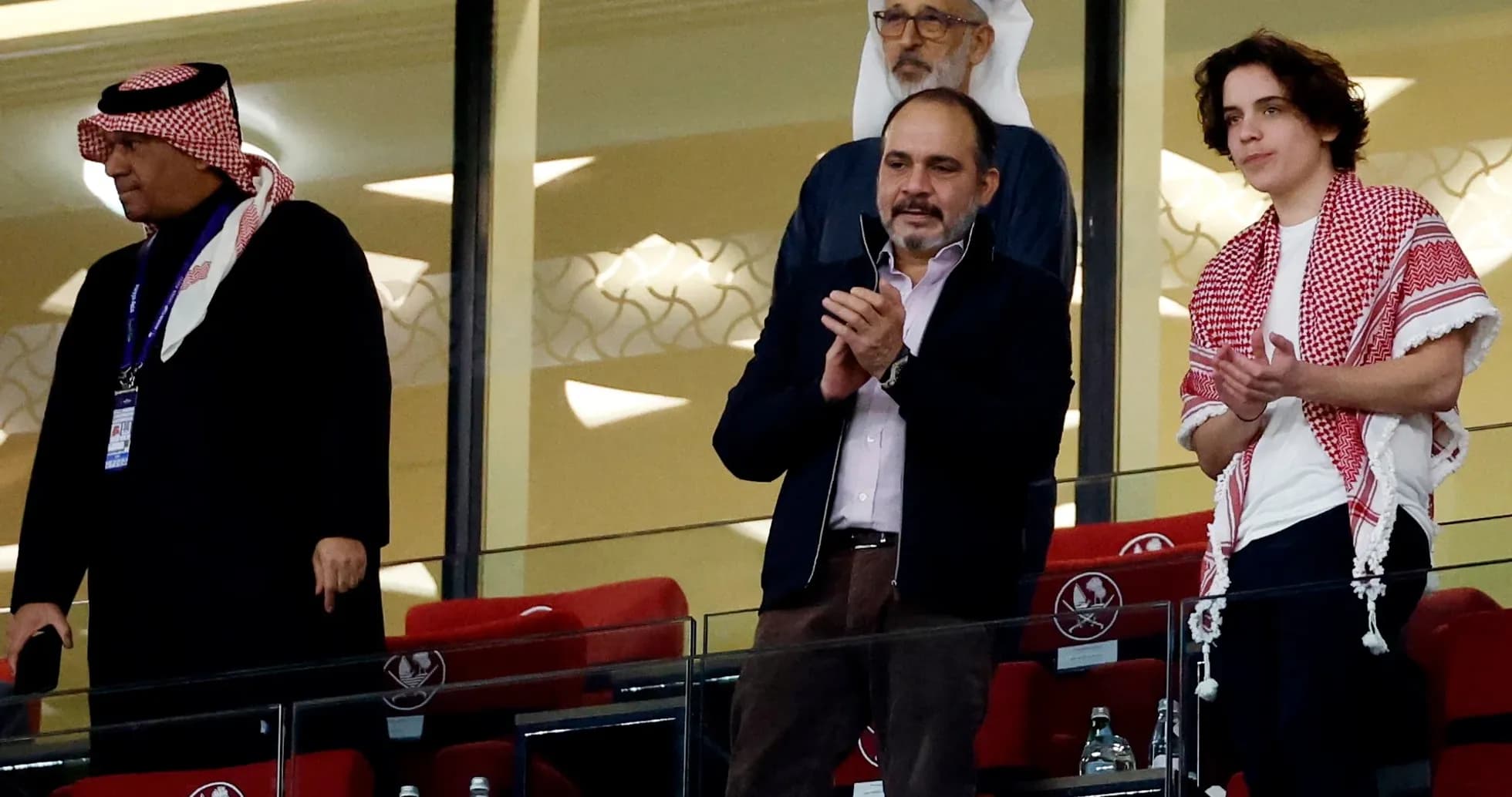 Group of spectators applauding in stadium box
