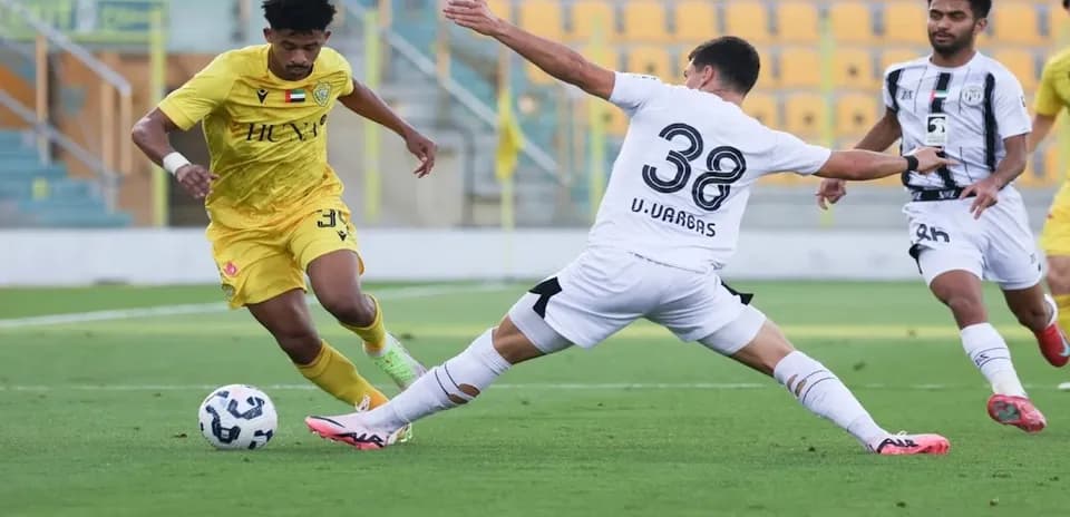 Al Wasl U23 player evading tackle from Al Jazira U23