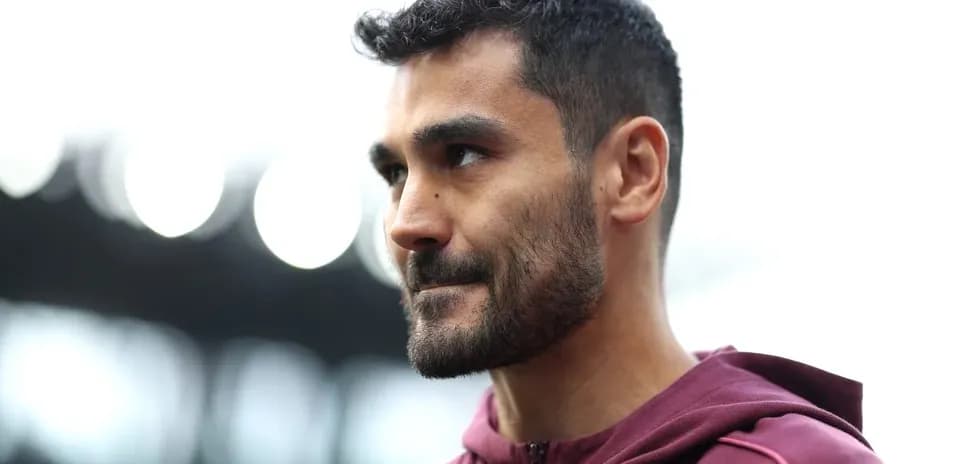 Player in maroon hoodie at stadium