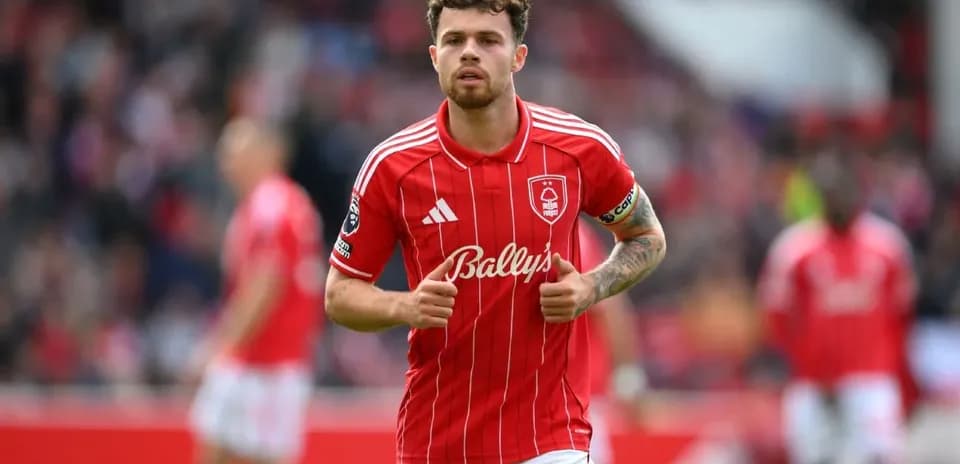 Player in red jersey walking on the pitch