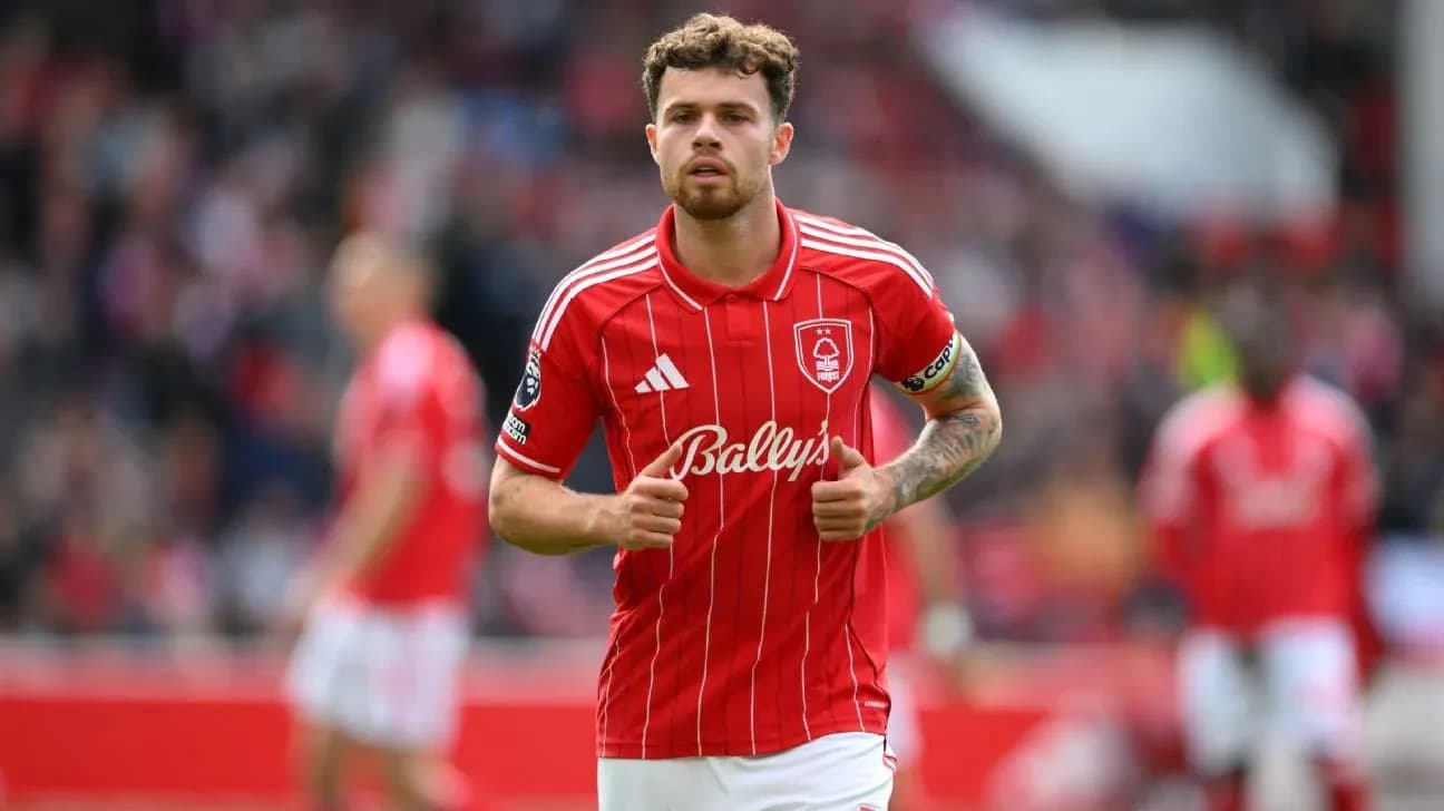 Player in red jersey walking on the pitch