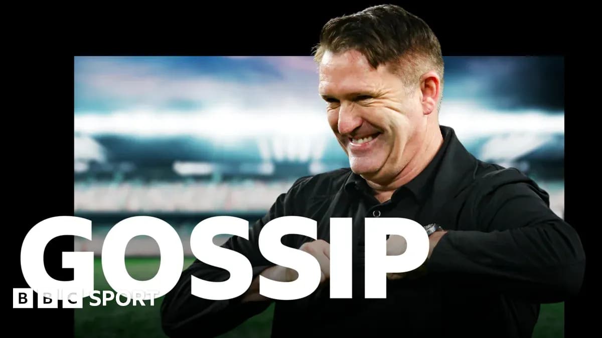 Man smiling in front of a sports stadium backdrop