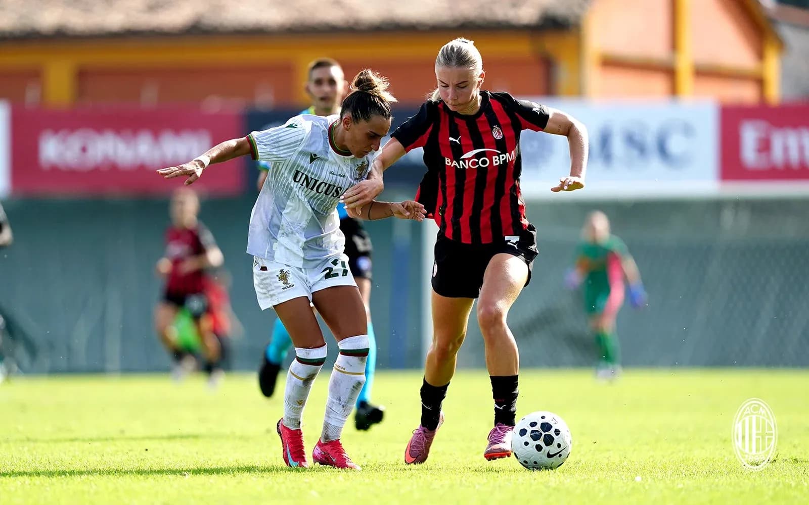 Two players competing for the ball during match
