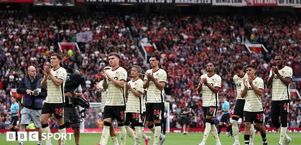 Players applauding fans after match at Old Trafford