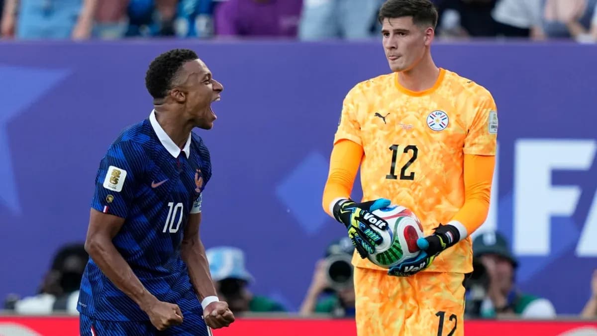 French player celebrating near Paraguayan goalkeeper