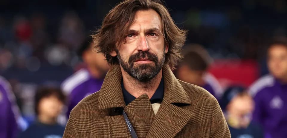 Man in brown coat at a sports event