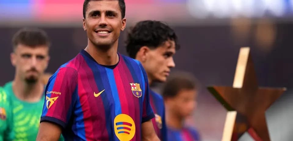 Player smiling with trophy during team celebration