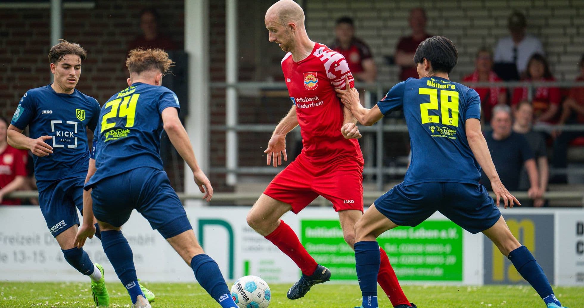 Players competing for the ball in Oberliga match
