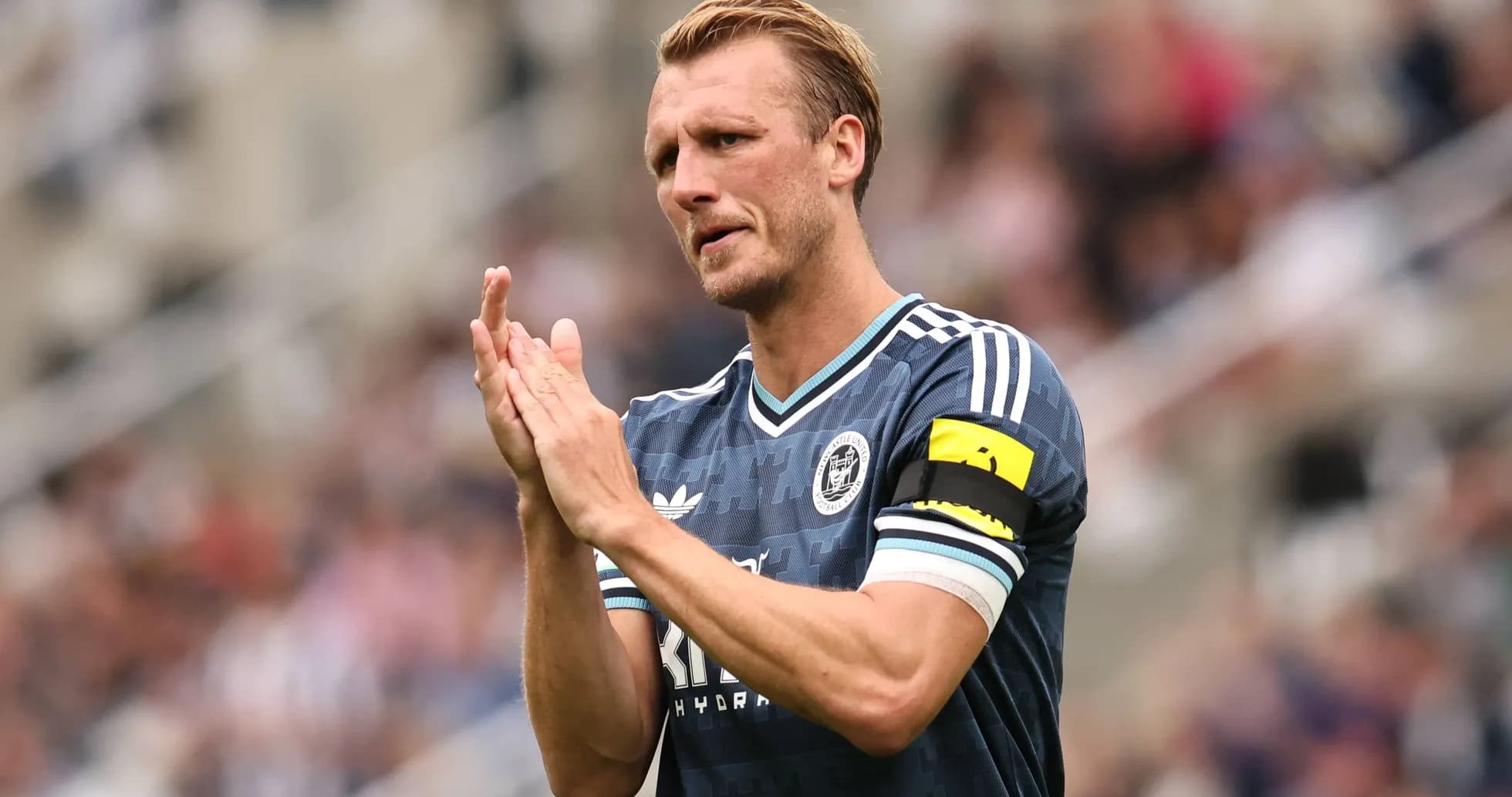 Player clapping while wearing captain's armband