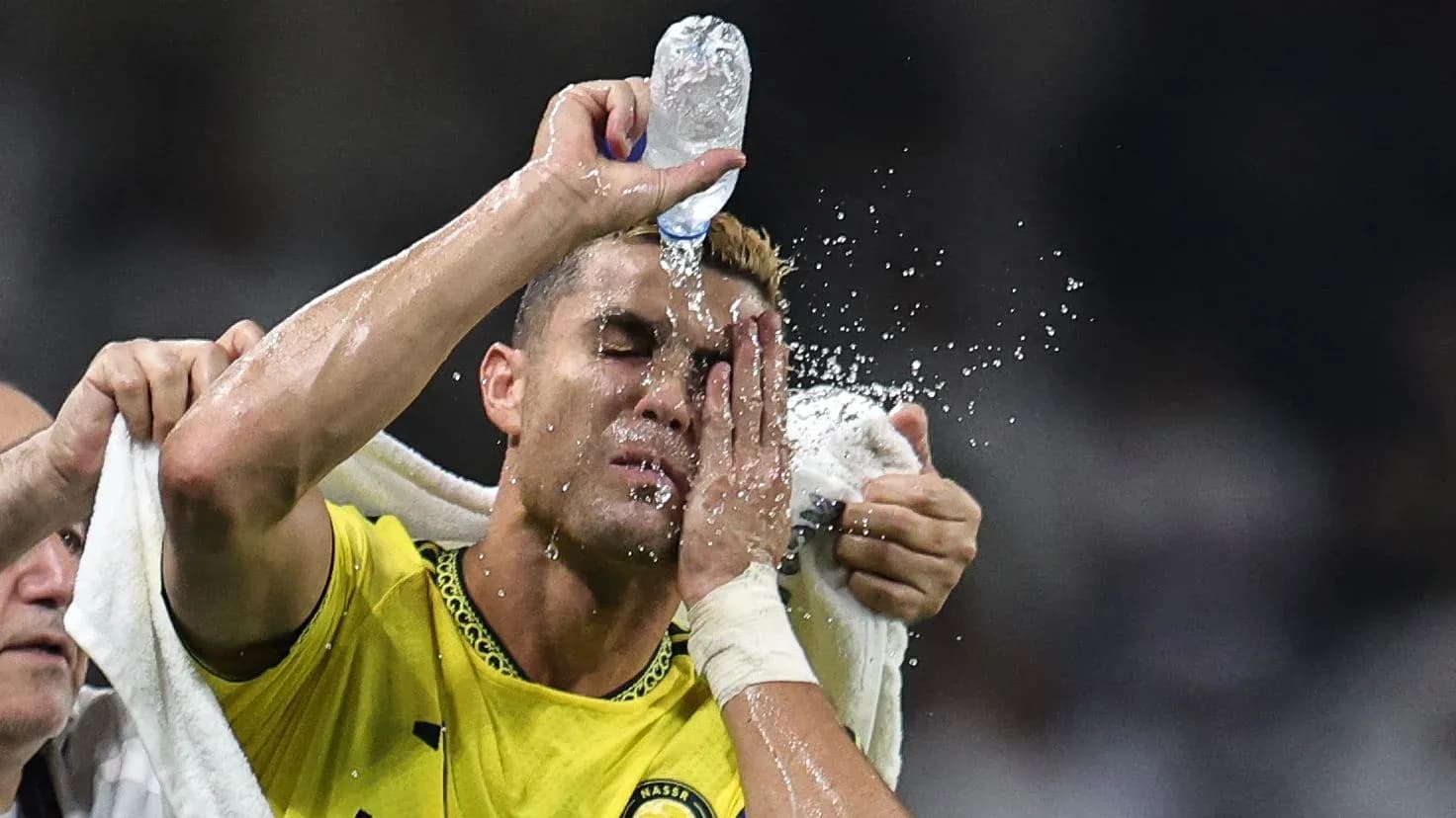 Player cooling down with water during match