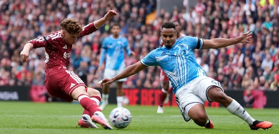 Player tackling another during competitive football match