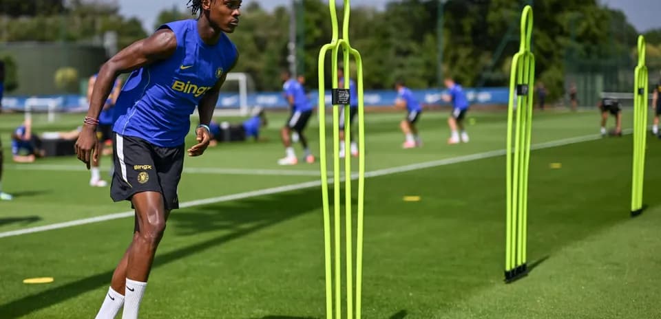 Player training with agility poles on practice field