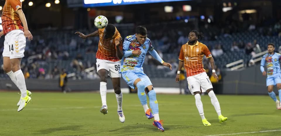Players competing for the ball during USL match