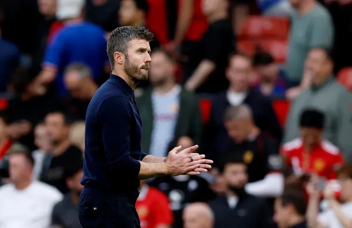 Coach clapping during match at Old Trafford