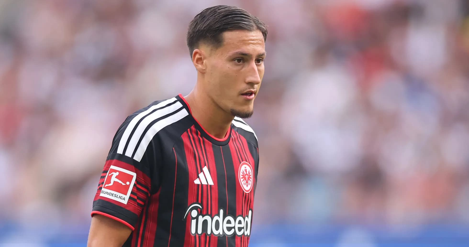Player in Eintracht Frankfurt jersey on field