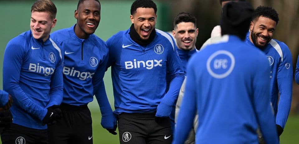 Players laughing during training session in blue kits