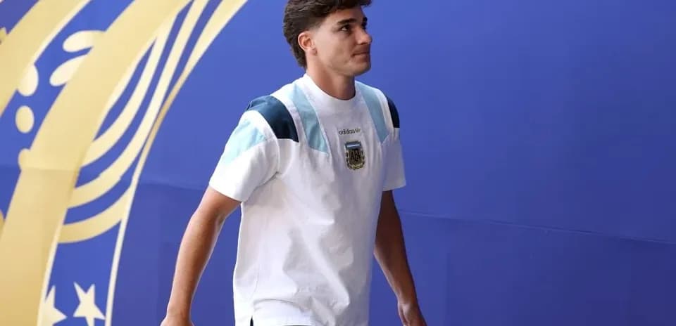 Player walking in front of a blue backdrop