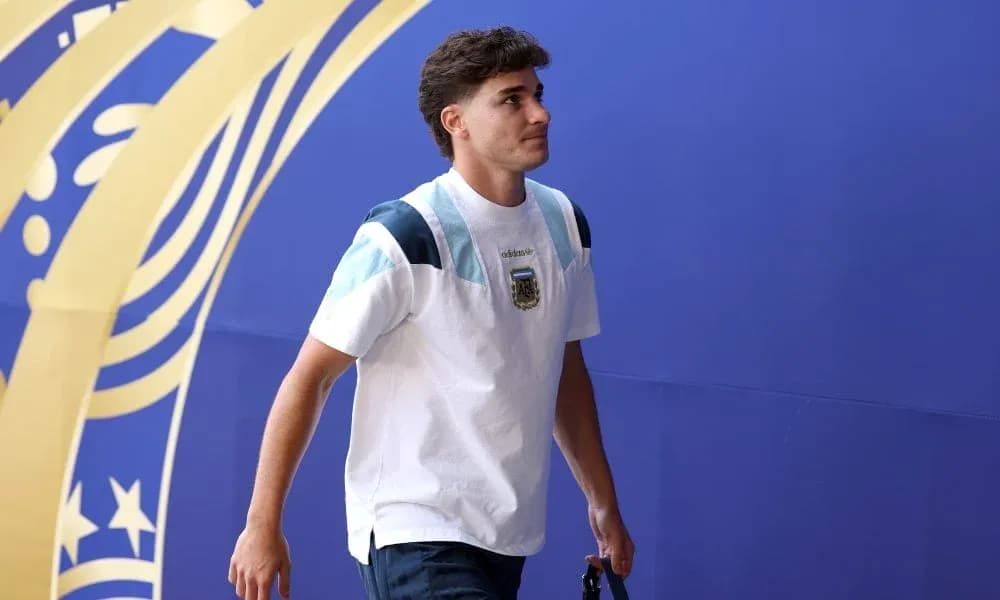Player walking in front of a blue backdrop