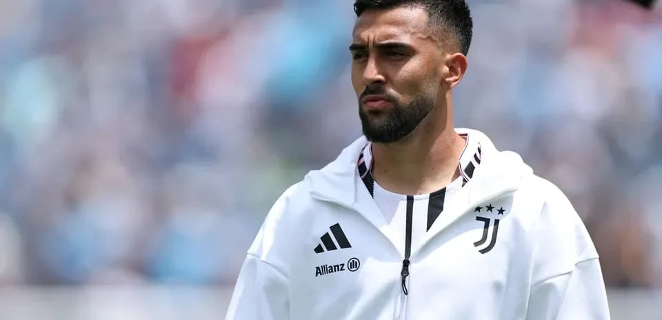 Player in Juventus jacket on the pitch