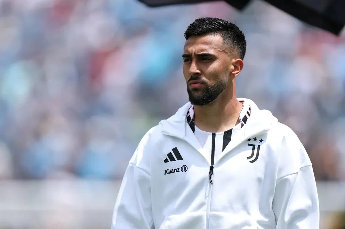 Player in Juventus jacket on the pitch