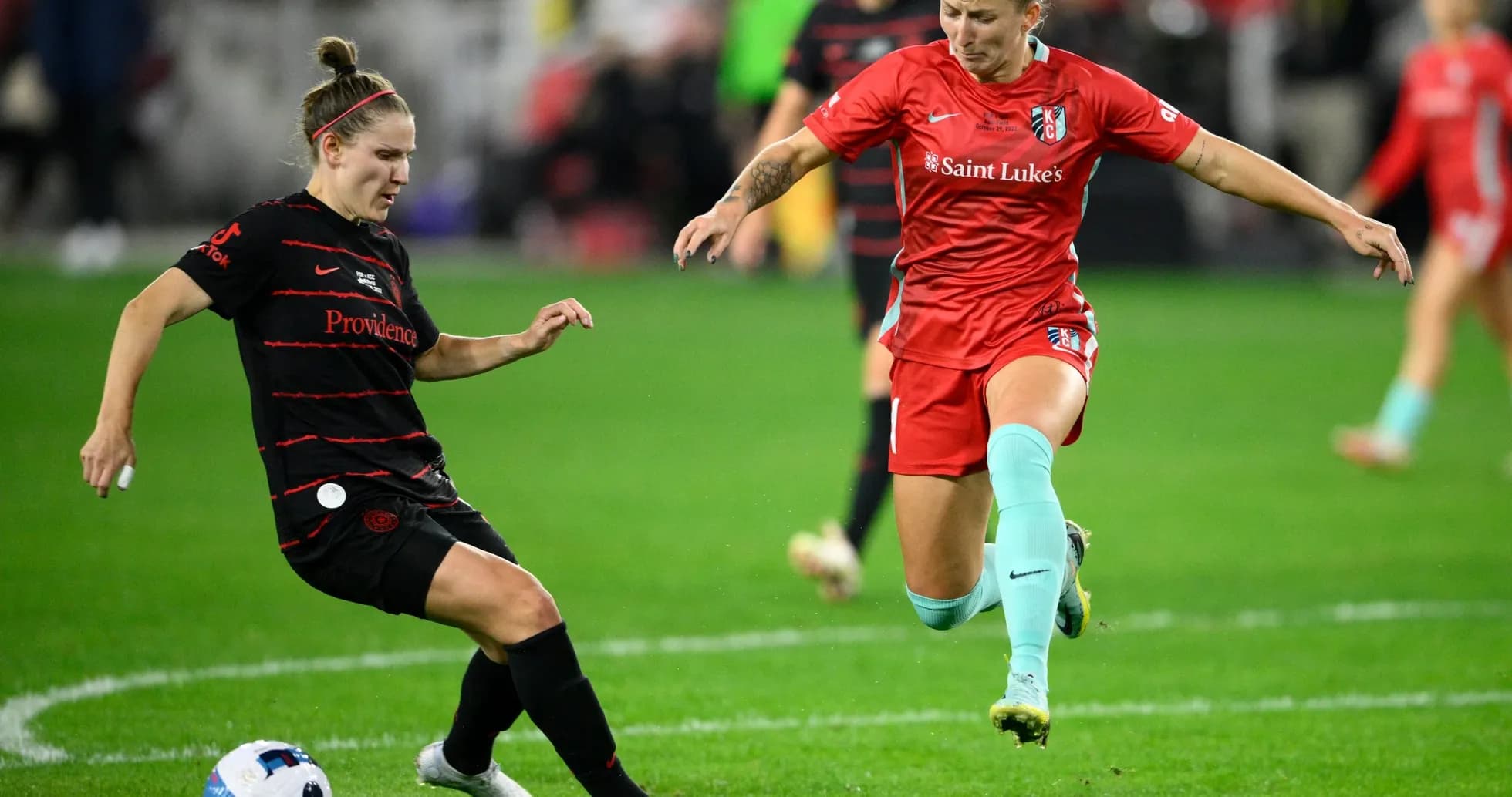 Kansas City player challenging Portland Thorns player