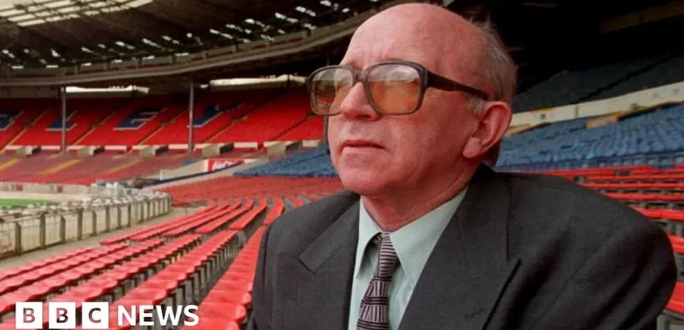 Man sitting in empty stadium stands at Wembley