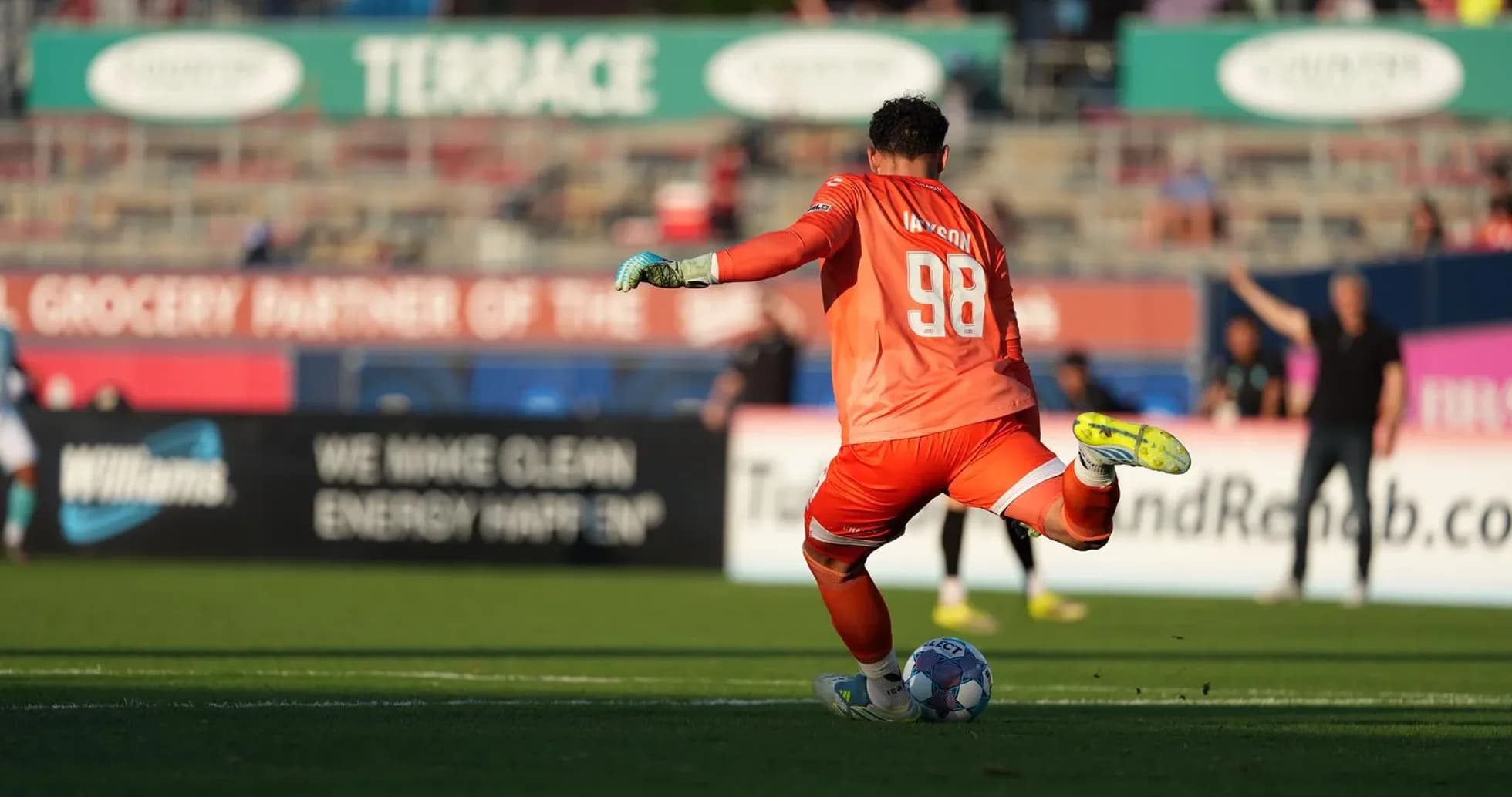 Goalkeeper preparing to kick the ball during match