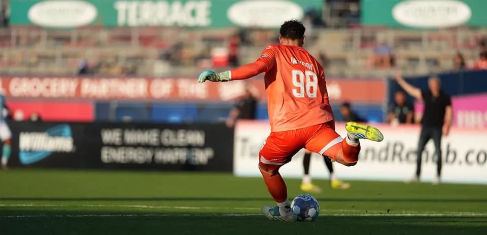 Goalkeeper preparing to kick the ball during match