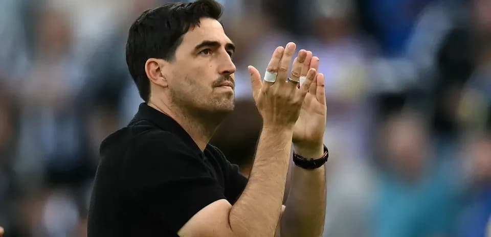 Coach applauding the crowd during a match